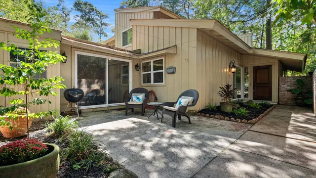 a view of a house with backyard sitting area and garden