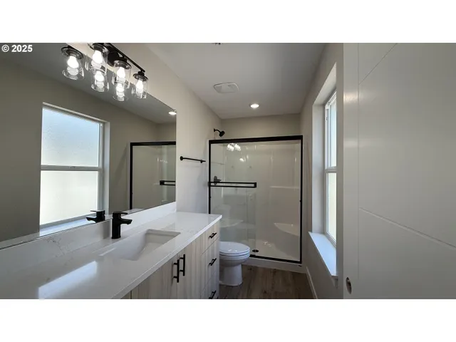 a bathroom with a sink a large mirror and shower