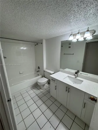 a bathroom with a double vanity sink mirror and toilet