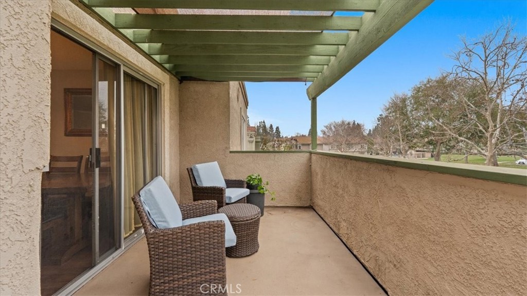 8425 Sunset Trail Place, Unit F Rancho Cucamonga, CA 91730 - Photo 16 of 28 a balcony with chairs and a table