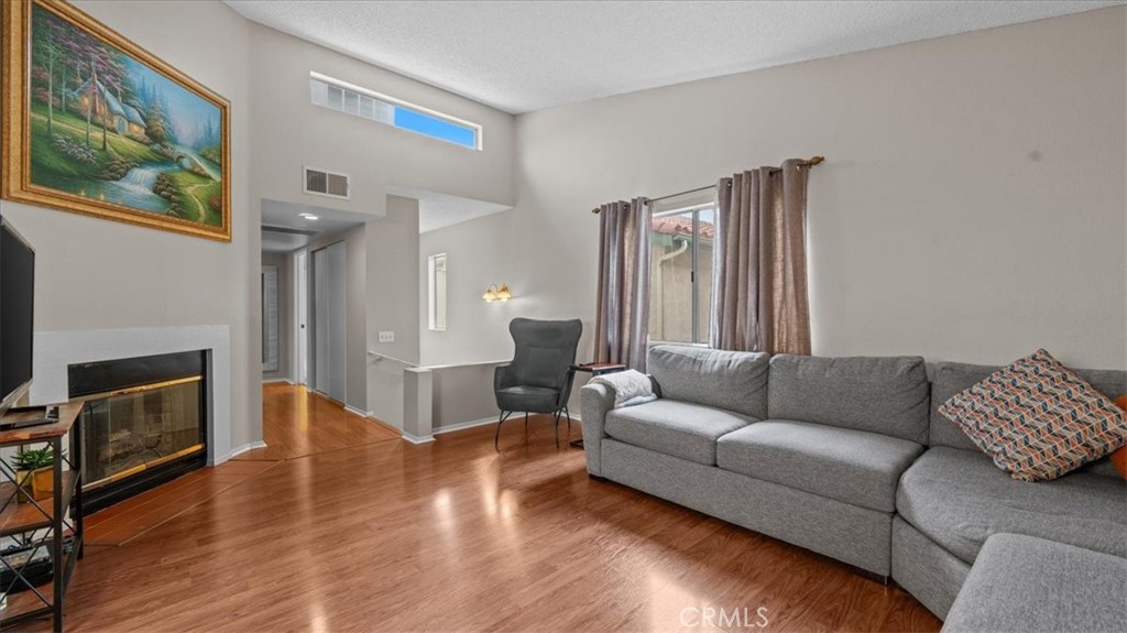 8425 Sunset Trail Place, Unit F Rancho Cucamonga, CA 91730 - Photo 4 of 28 a living room with furniture and a fireplace