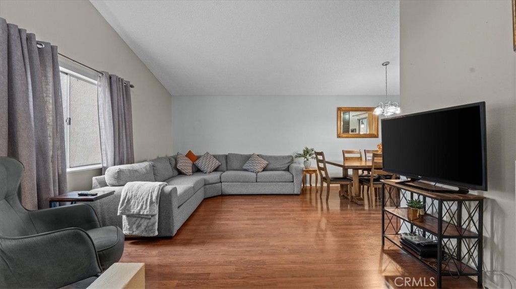 8425 Sunset Trail Place, Unit F Rancho Cucamonga, CA 91730 - Photo 5 of 28 a living room with furniture and a flat screen tv