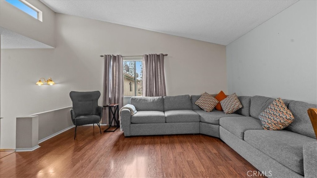 8425 Sunset Trail Place, Unit F Rancho Cucamonga, CA 91730 - Photo 27 of 28 a living room with furniture and a window