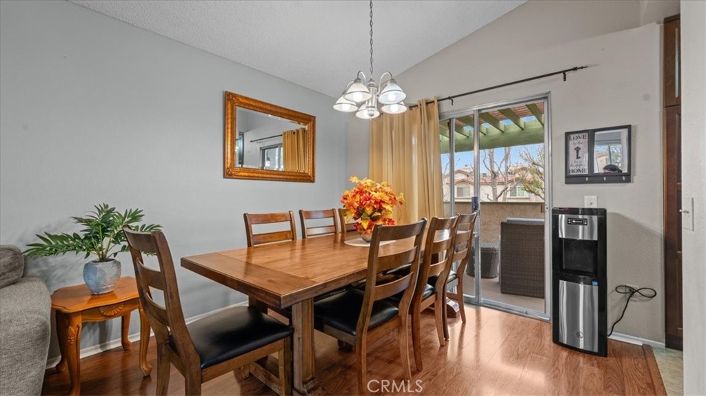 8425 Sunset Trail Place, Unit F Rancho Cucamonga, CA 91730 - Photo 6 of 28 a dining room with furniture a chandelier and wooden floor