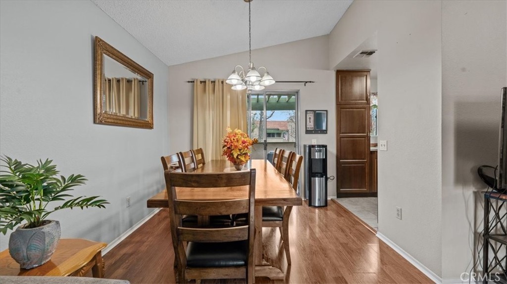 8425 Sunset Trail Place, Unit F Rancho Cucamonga, CA 91730 - Photo 7 of 28 a view of a dining room with furniture window and wooden floor