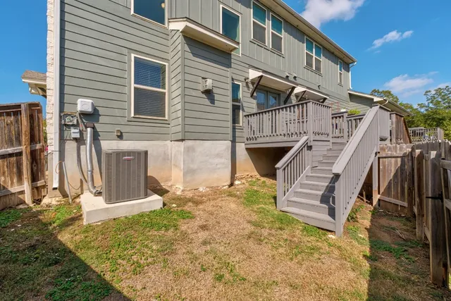 a view of a backyard with wooden fence