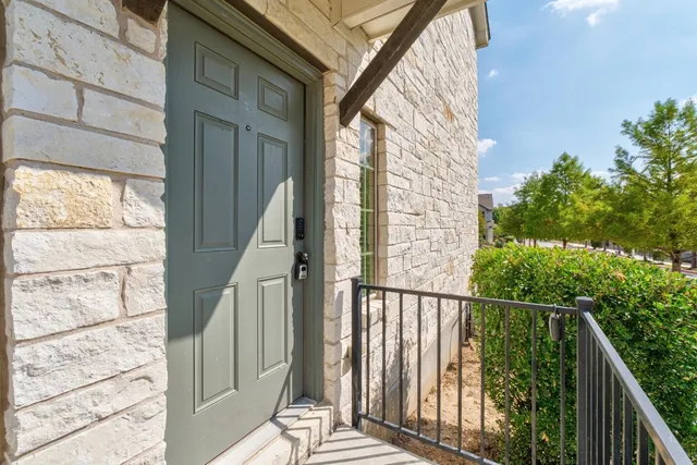 a view of a balcony with wooden floor and fence
