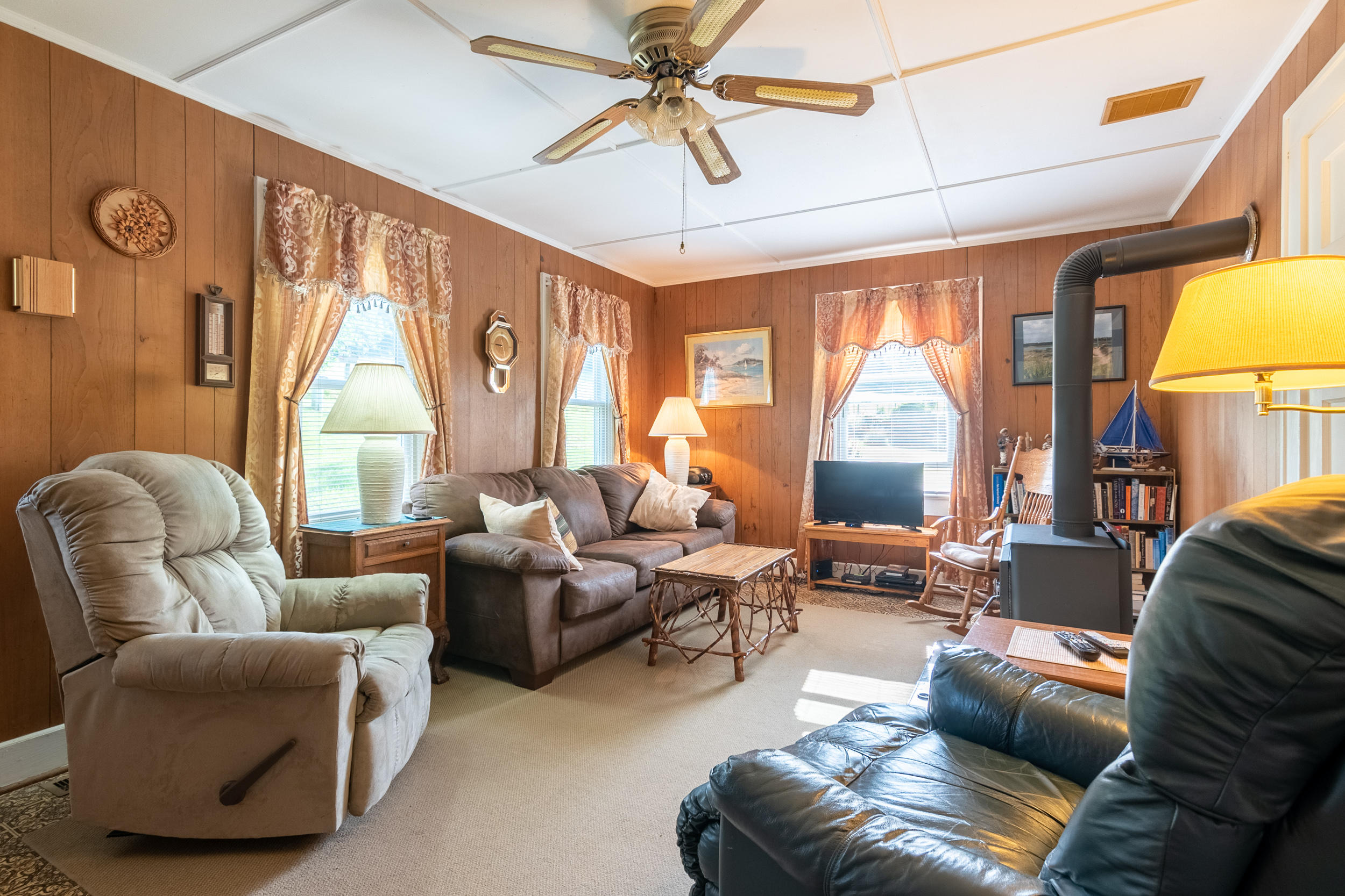 856 Conner Grove Road Southwest Willis, VA 24380 - Photo 14 of 63 a living room with furniture ceiling fan and a large window