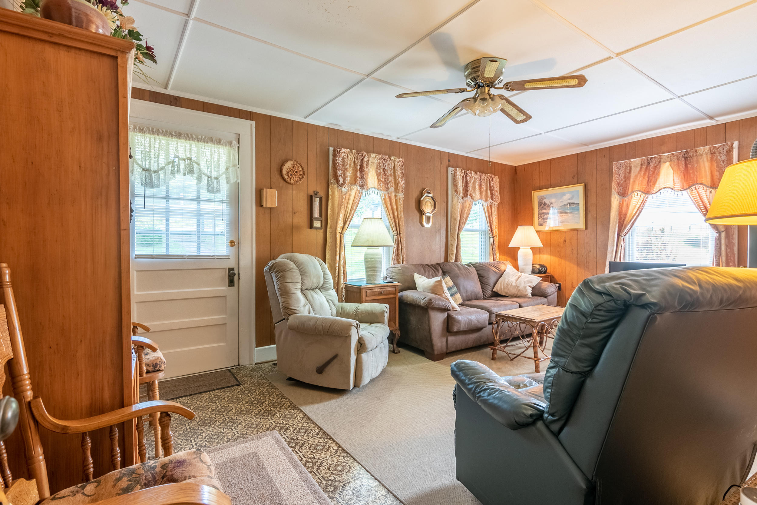 856 Conner Grove Road Southwest Willis, VA 24380 - Photo 16 of 63 a living room with furniture a chandelier and a window