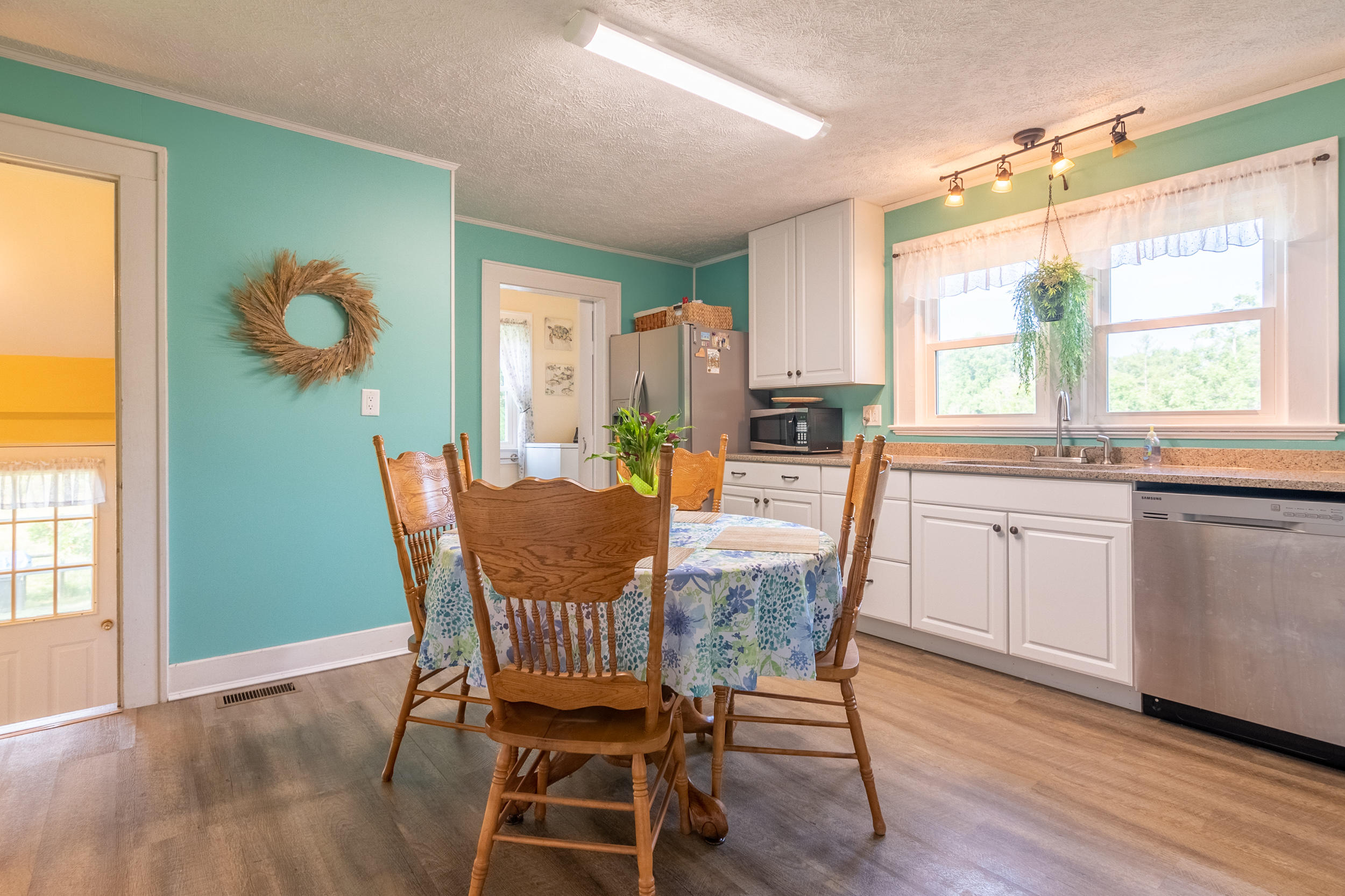 856 Conner Grove Road Southwest Willis, VA 24380 - Photo 25 of 63 a dining room with furniture a window and wooden floor