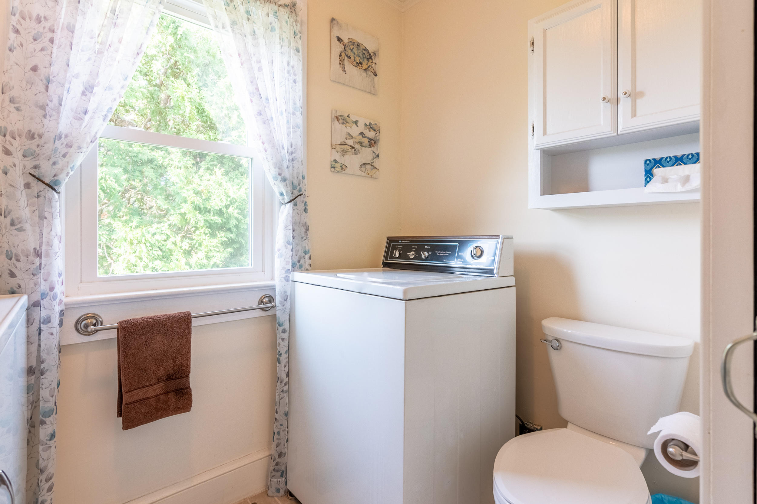856 Conner Grove Road Southwest Willis, VA 24380 - Photo 30 of 63 a bathroom with a toilet a sink and a window