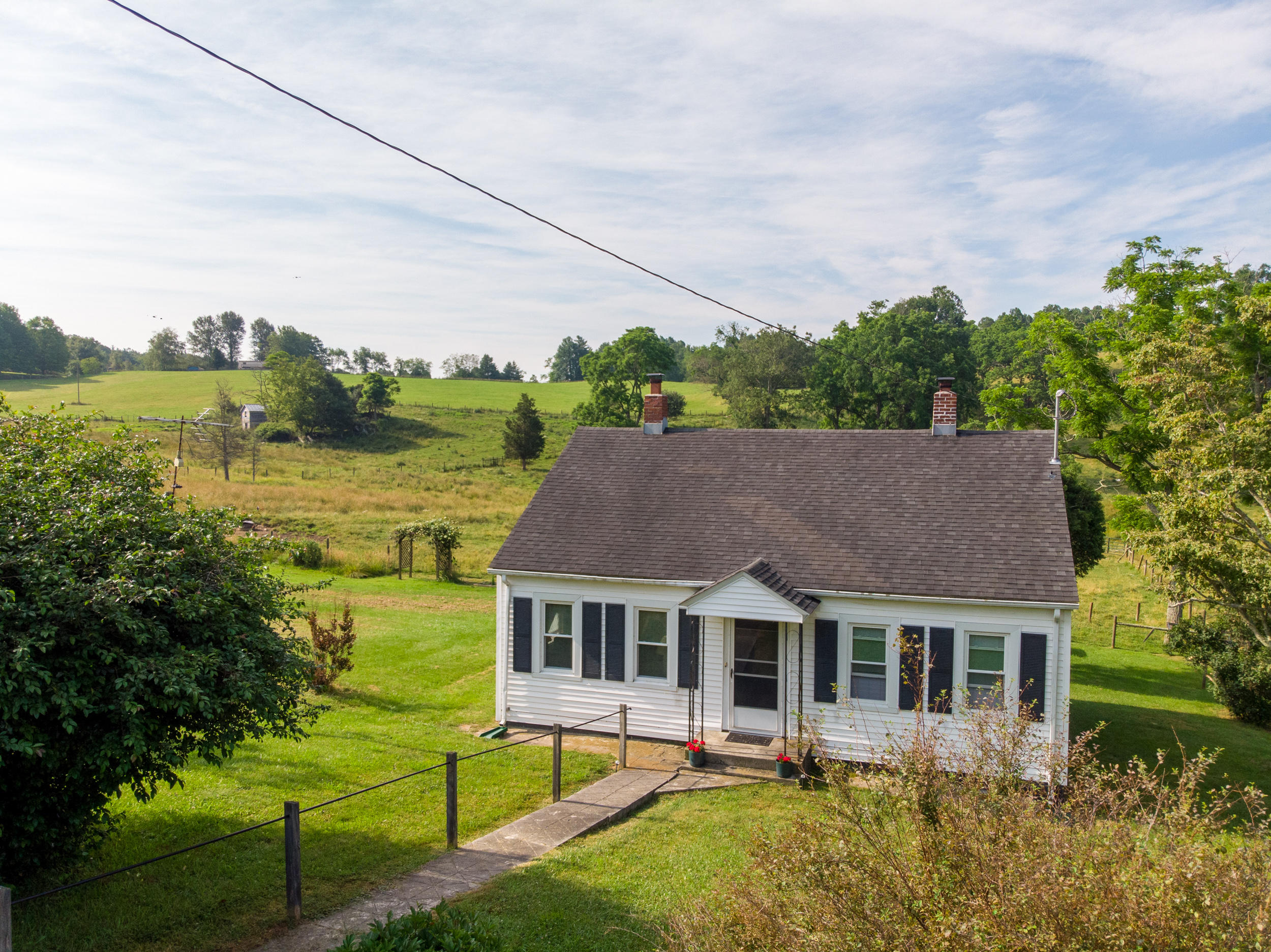 856 Conner Grove Road Southwest Willis, VA 24380 - Photo 5 of 63 a aerial view of a house with swimming pool and a yard