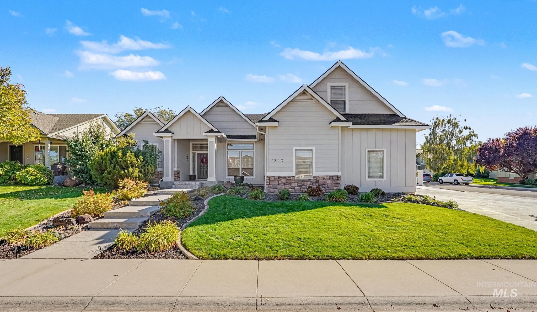 2340 South Alaska Way Meridian, ID 83642 - Photo 2 of 48 Light-toned exterior with board and batten siding, stone accents, and a covered entry