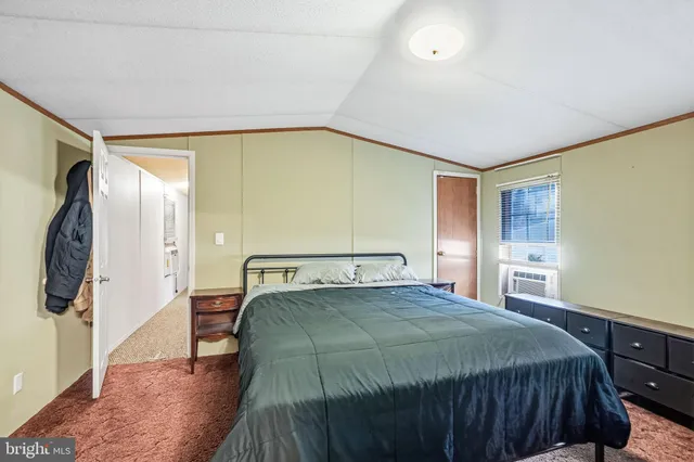 a bedroom with a bed and a mirror