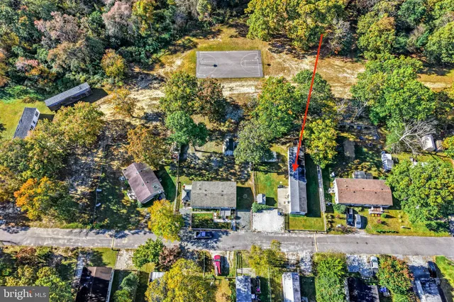 an aerial view of a house with a yard and lake view