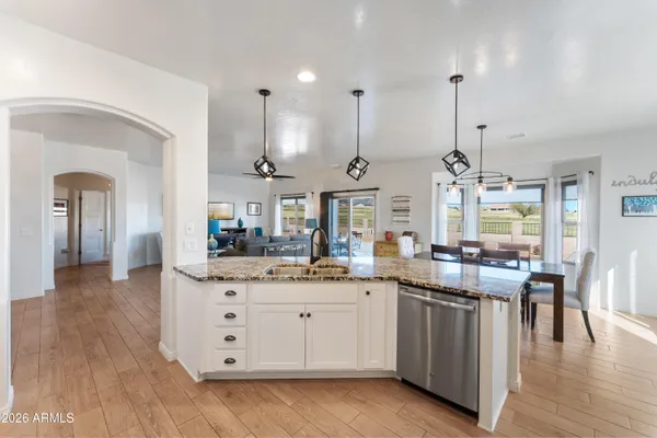 a kitchen with stainless steel appliances kitchen island granite countertop a sink and cabinets