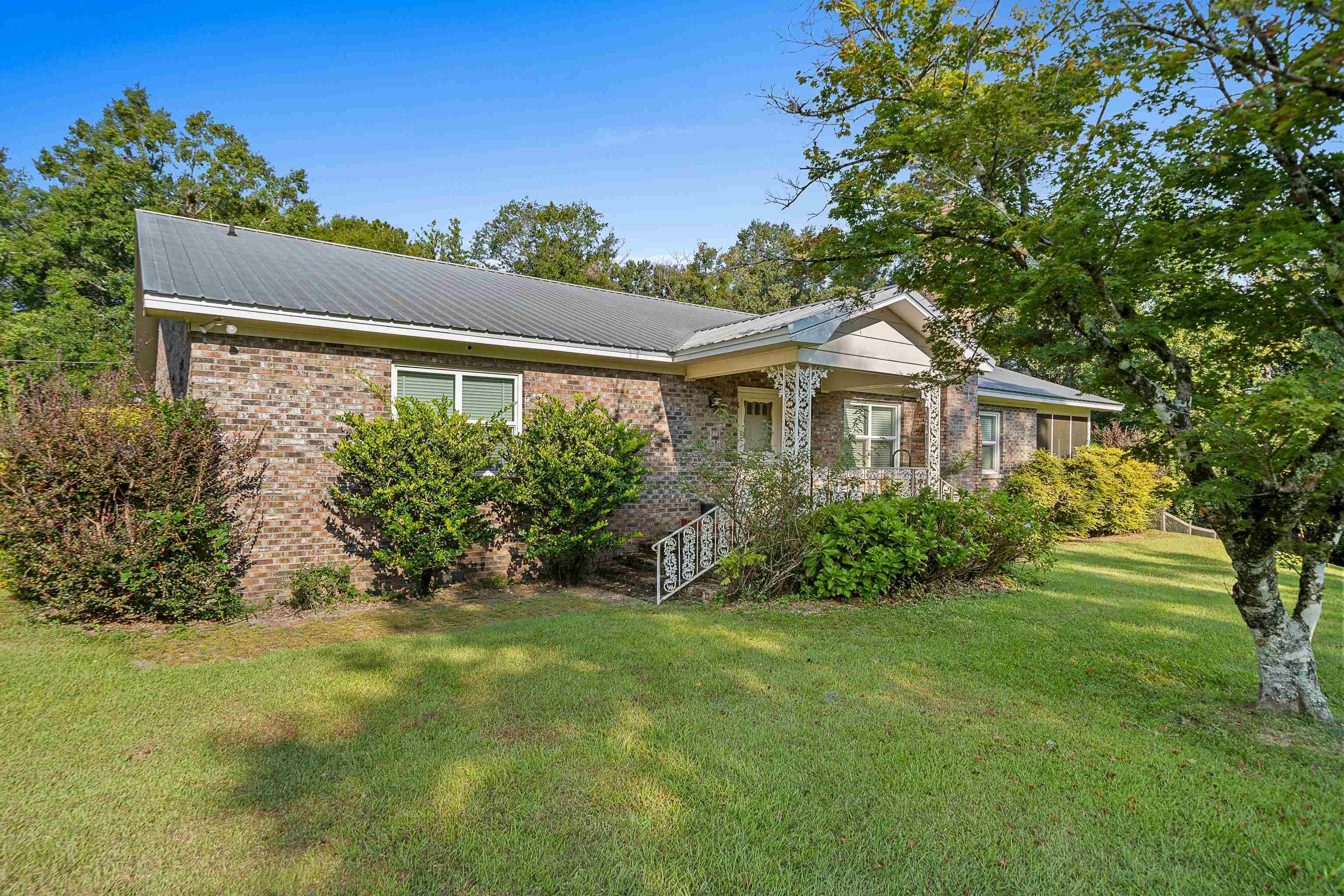 9350 Tompkins Road Stockton, AL 36579 - Photo 12 of 36 Ranch-style home with a metal roof, brick siding, and a front lawn