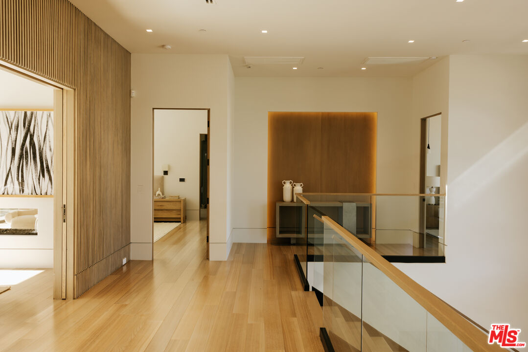 219 Homewood Road Los Angeles, CA 90049 - Photo 14 of 40 a view of a hallway with wooden floor and staircase
