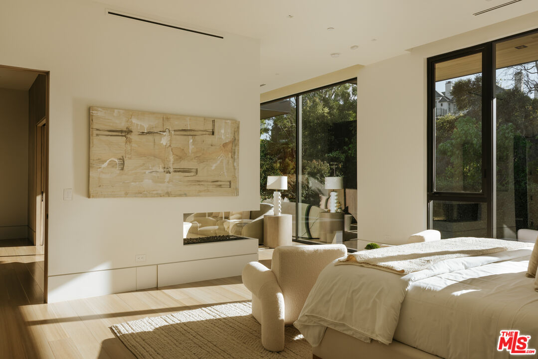 219 Homewood Road Los Angeles, CA 90049 - Photo 17 of 40 a bedroom with a bed and large window with outer view