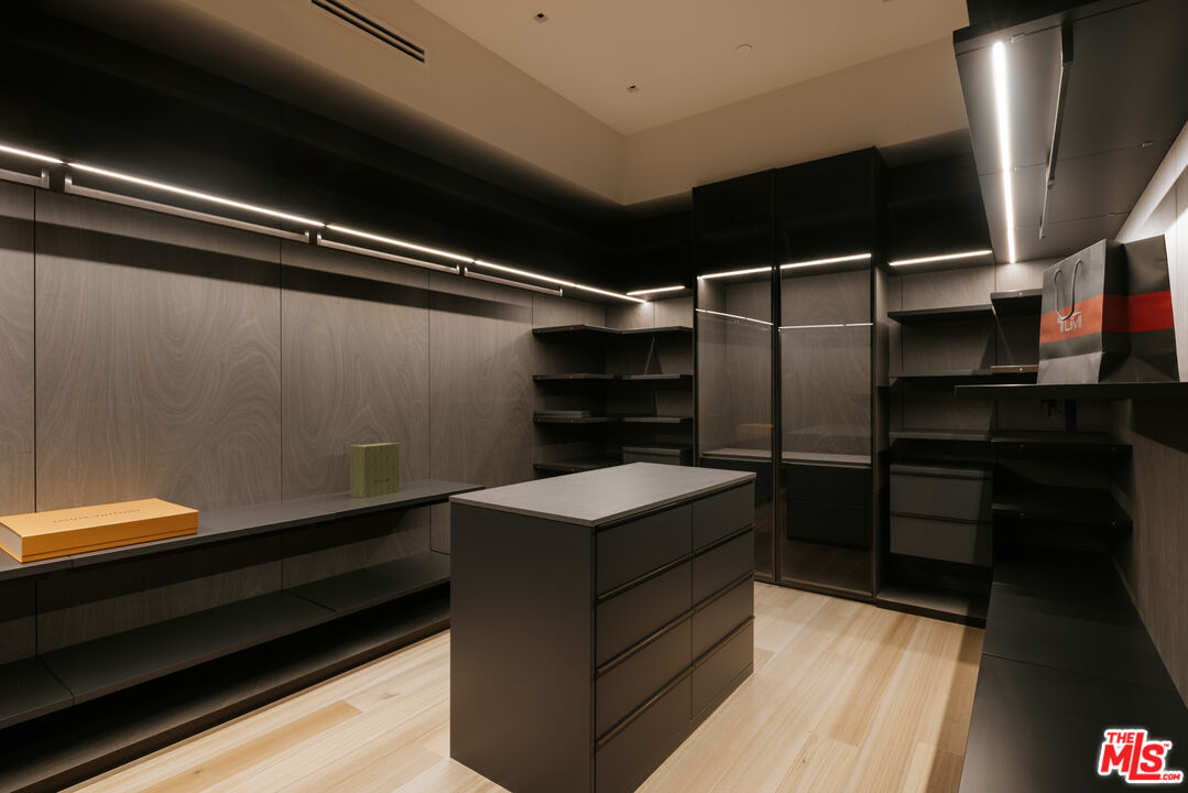 219 Homewood Road Los Angeles, CA 90049 - Photo 19 of 40 a kitchen with kitchen island white cabinets and black appliances