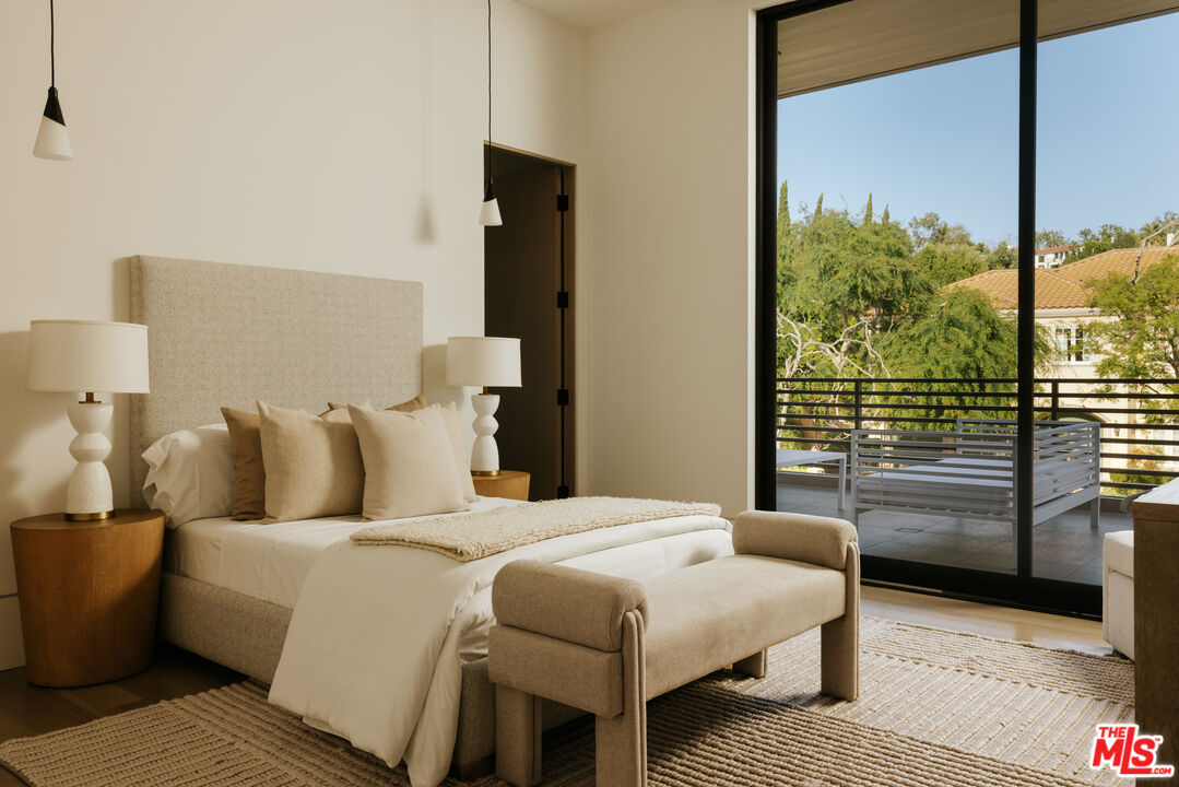 219 Homewood Road Los Angeles, CA 90049 - Photo 20 of 40 a bedroom with a bed and wooden floor