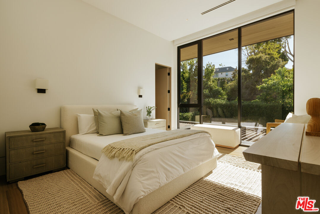 219 Homewood Road Los Angeles, CA 90049 - Photo 22 of 40 a bedroom with a bed and a large window
