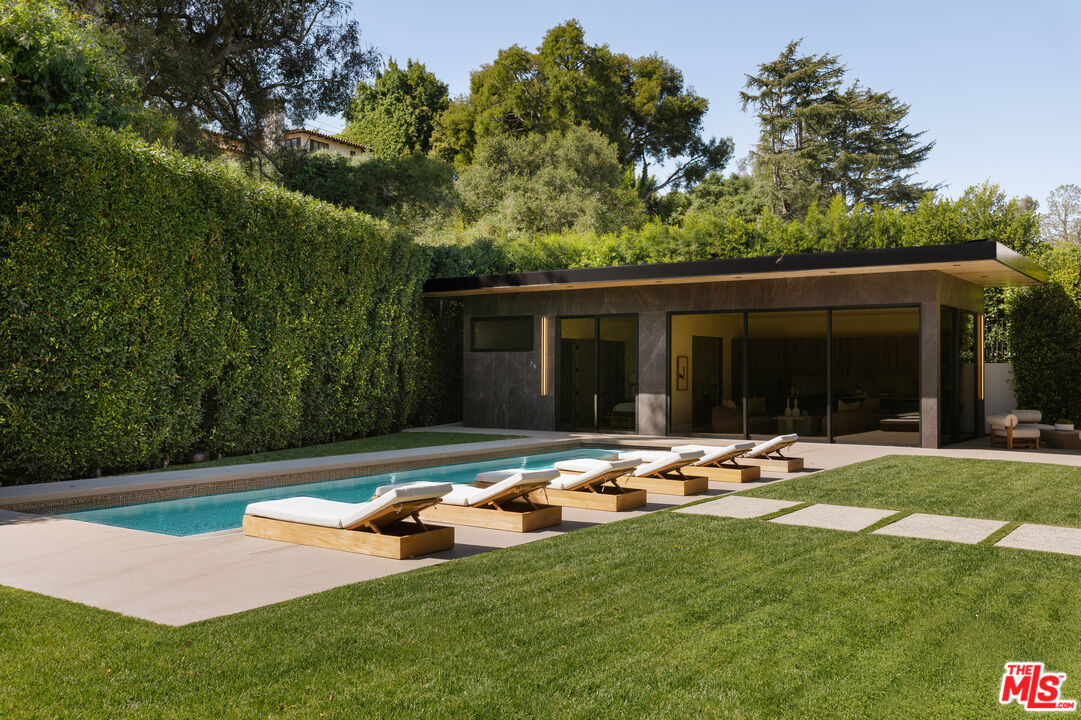 219 Homewood Road Los Angeles, CA 90049 - Photo 23 of 40 a front view of a house with garden