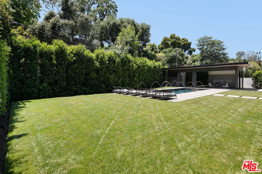 219 Homewood Road Los Angeles, CA 90049 - Photo 5 of 40 a swimming pool with outdoor seating and yard