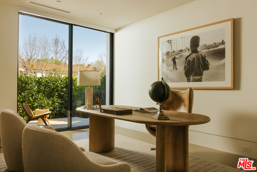 219 Homewood Road Los Angeles, CA 90049 - Photo 7 of 40 a living room with furniture and a floor to ceiling window