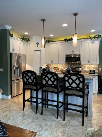 a kitchen with sink cabinets and stainless steel appliances
