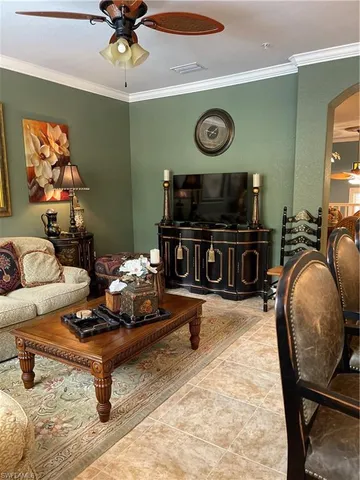a dining room with furniture and a chandelier