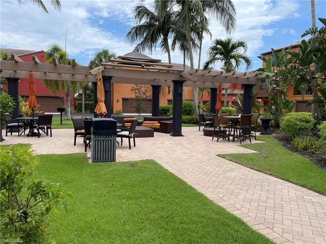 a swimming pool with outdoor seating and yard