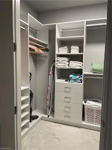 a bathroom with a granite countertop sink a mirror and a bathtub