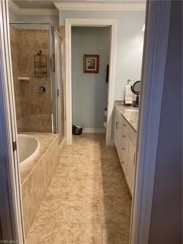 a bathroom with a granite countertop double sink and a mirror