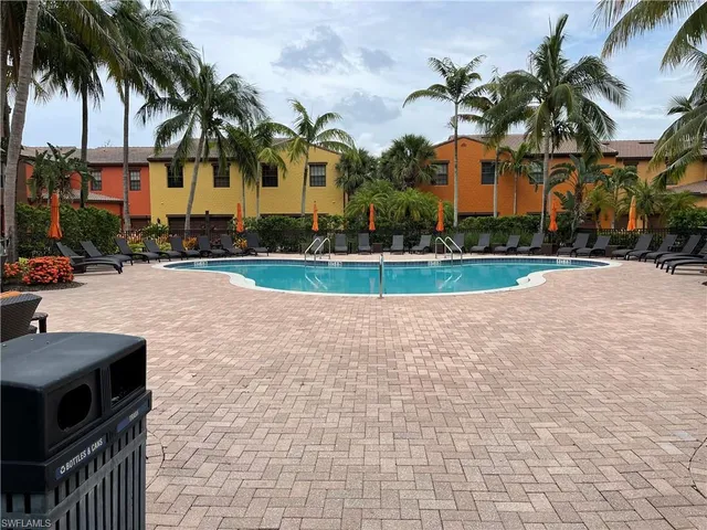 a bedroom with bed and a painting on the wall