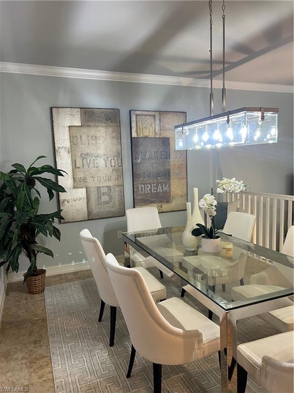9081 Albion Lane South, Unit 6510 Naples, FL 34113 - Photo 10 of 31 a living room with furniture and a chandelier