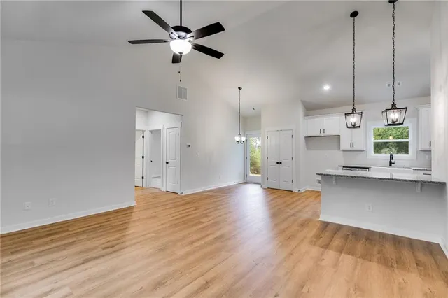 a view of a kitchen with a sink and wooden floor