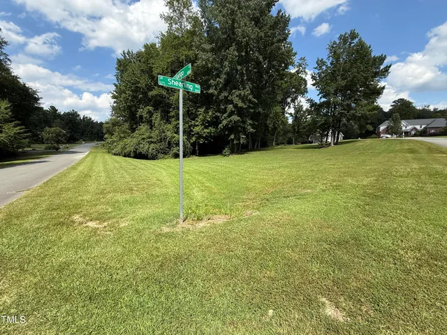 a view of a field with an trees