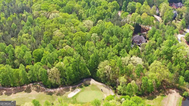 an aerial view of a house with a yard and garden