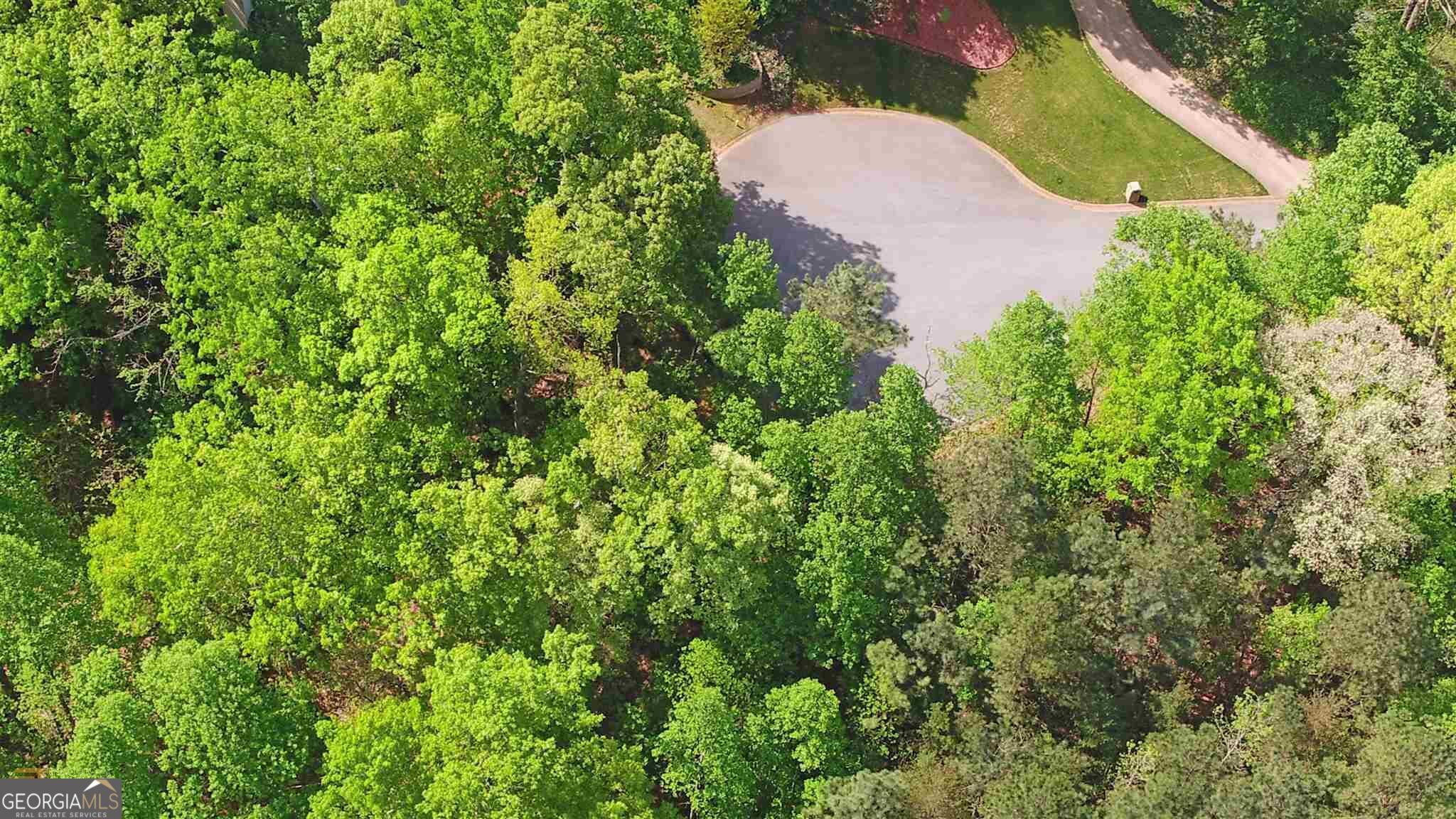 4835 Upper Berkshire Road Flowery Branch, GA 30542 - Photo 9 of 16 an aerial view of a house with a yard and garden