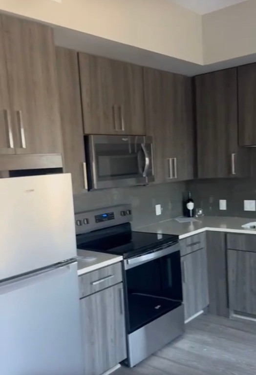 1475 Texas Street, Unit 415 Houston, TX 77002 - Photo 6 of 11 a kitchen with a sink a stove and cabinets