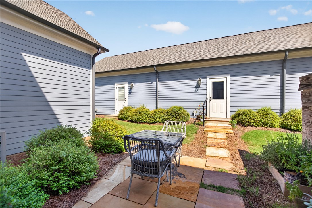 112 Tuttle Street Clemson, SC 29631 - Photo 4 of 46 A tranquil stone patio with verdant landscaping and convenient outdoor access points.