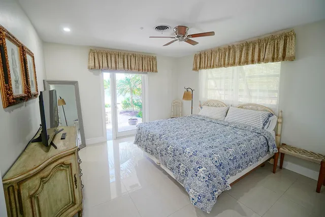 a bedroom with a bed a window and dresser