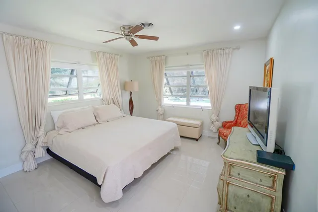 a bedroom with bed and window