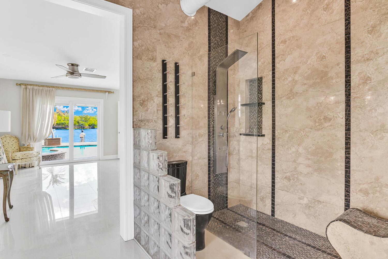 655 Castilla Lane Boynton Beach, FL 33435 - Photo 15 of 23 a bathroom with a granite countertop sink a toilet and shower