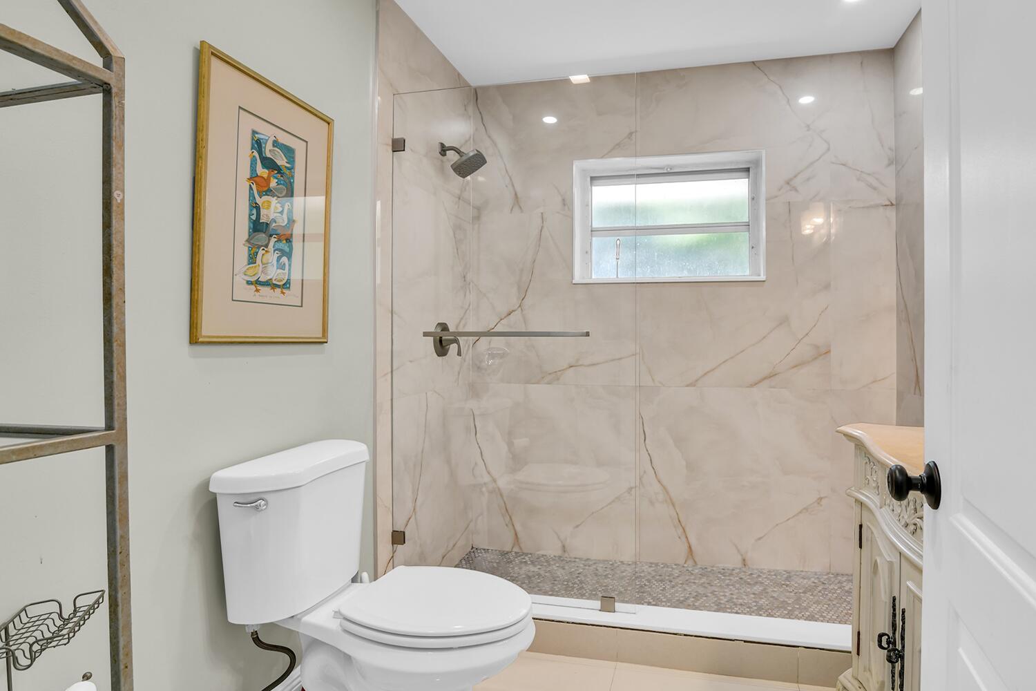 655 Castilla Lane Boynton Beach, FL 33435 - Photo 16 of 23 a white toilet sitting next to a bathroom sink