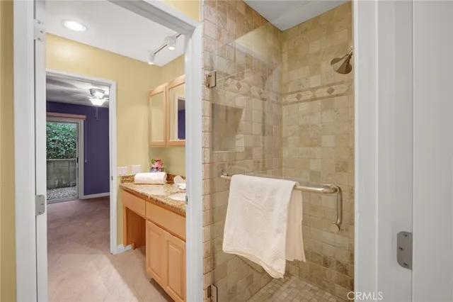 a bathroom with a granite countertop sink and a mirror