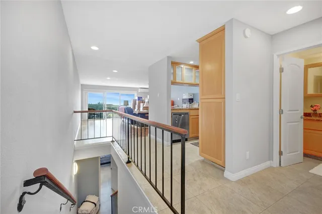 a view of an empty room with chandelier fan