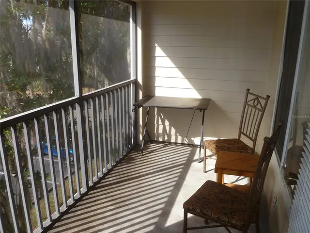 a view of a balcony with furniture