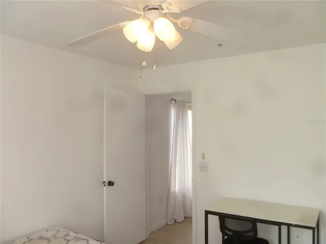a view of a chandelier fan and closet in a room
